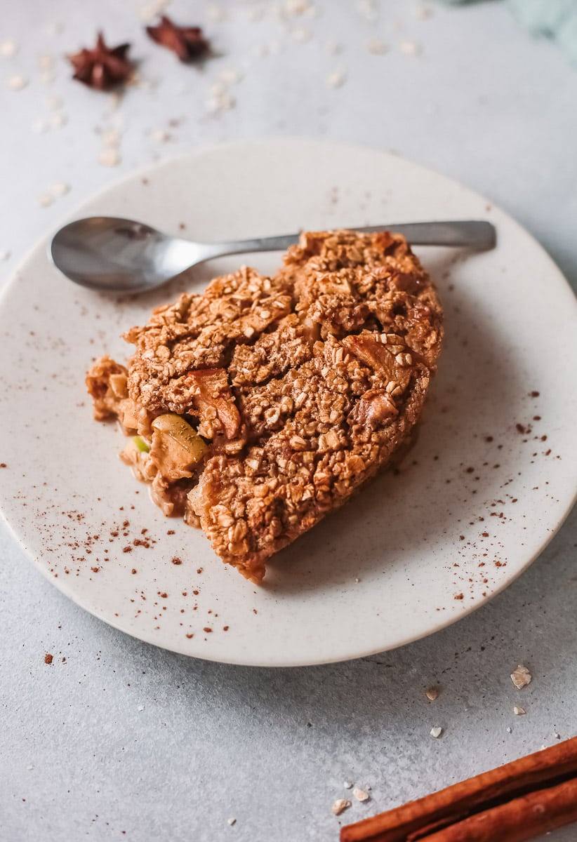 Close-up of a slice of apple cinnamon baked oatmeal with diced apples and rolled oats