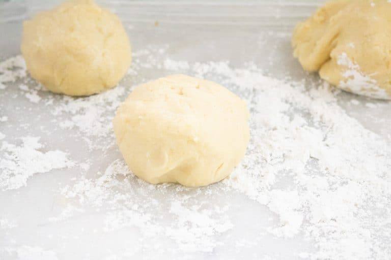 Two balls of dough for making Apple Butter Coffee Cake set on a floured counter