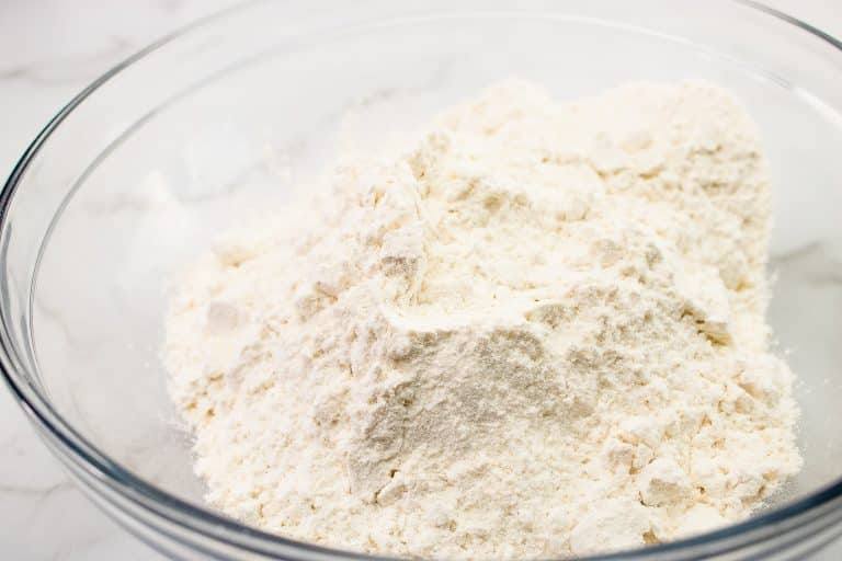 Flour in a glass mixing bowl for pie crust
