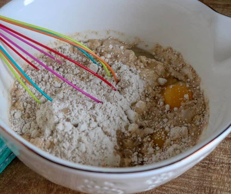 Spice cake mix, eggs, water and vegetable oil in a bowl being mixed with a whisk