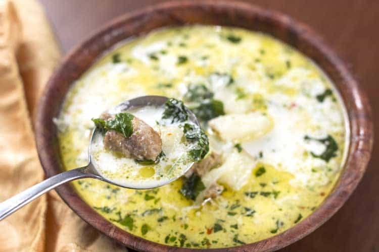 zuppa toscana soup being served in brown bowl