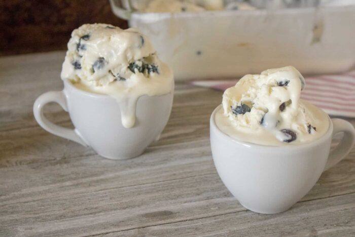 two servings of blueberry lemon no-churn homemade ice cream served in white ceramic mugs