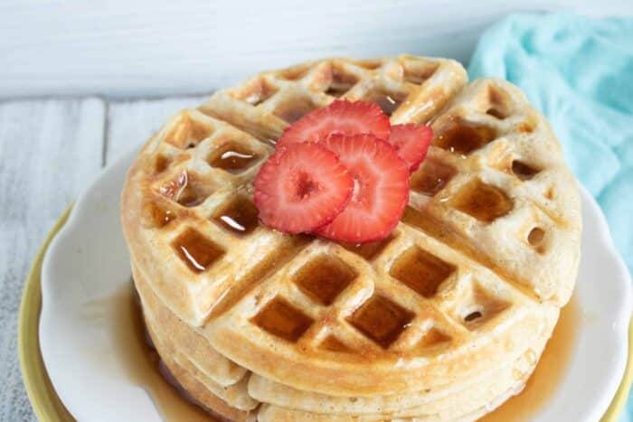 belgian waffles with strawberries on white plate