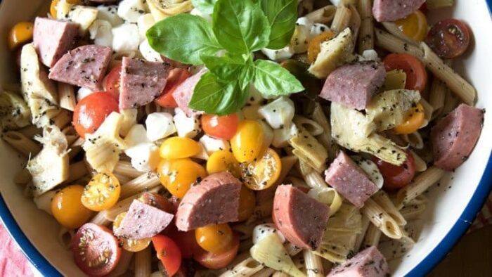 Fresh, flavorful salad that can be enjoyed any time of the year. This Caprese Pasta Salad recipe with Artisinal Sauasage is the best pasta salad recipe to bring to a potluck.
