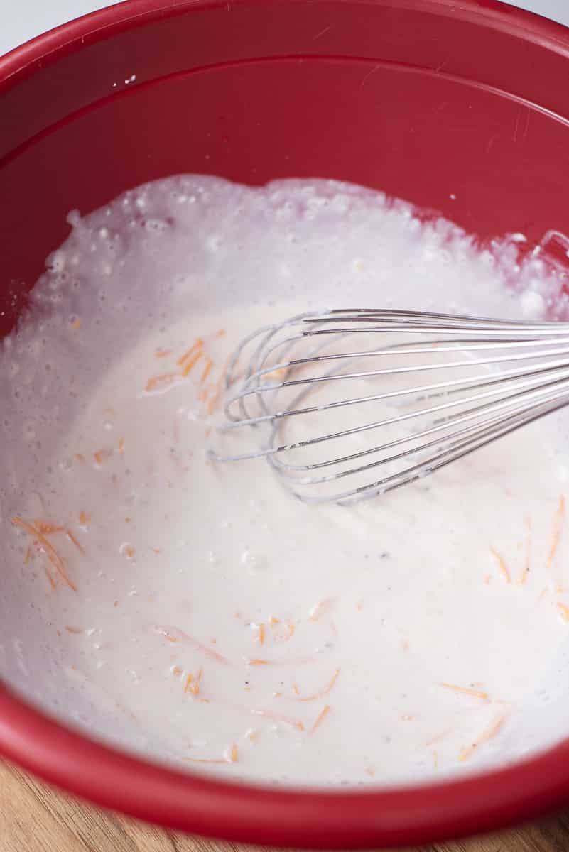 mixing cheese sauce for pierogi casserole