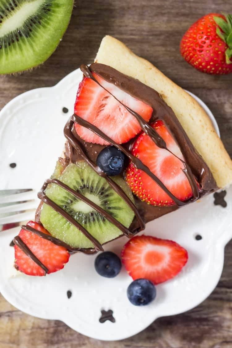 Chocolate fruit pizza is always a total crowd pleaser. With chewy sugar cookie, creamy chocolate cream cheese topping & fresh berries - you can't go wrong!