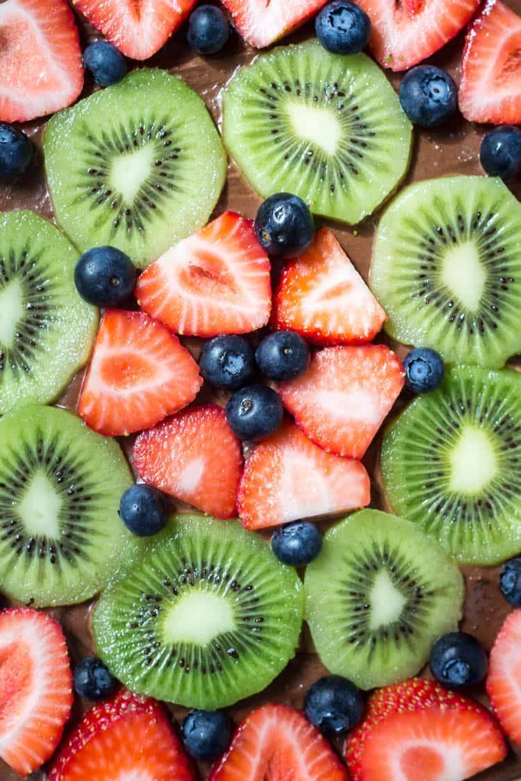 Chocolate fruit pizza is always a total crowd pleaser. With chewy sugar cookie, creamy chocolate cream cheese topping & fresh berries - you can't go wrong!
