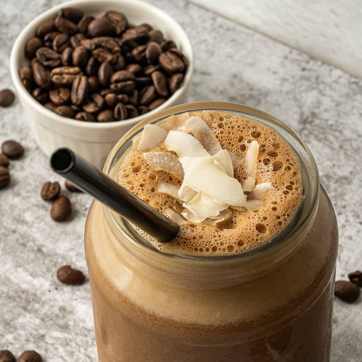 chocolate protein shake in a jar with a straw