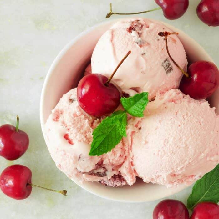 homemade copycat cherry garcia ice cream in a white bowl