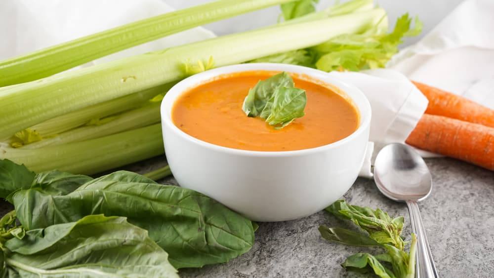 Side view of a bowl of copycat Panera tomato soup