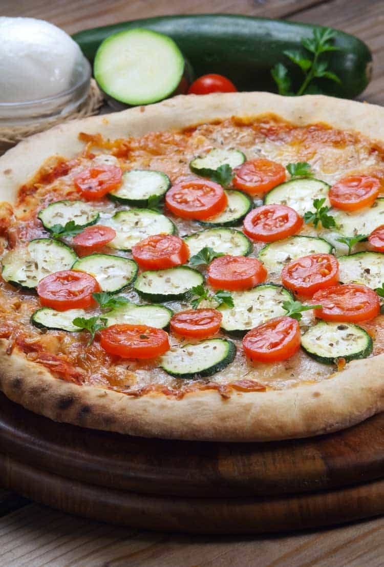 vegetarian pizza with zucchini on wood table