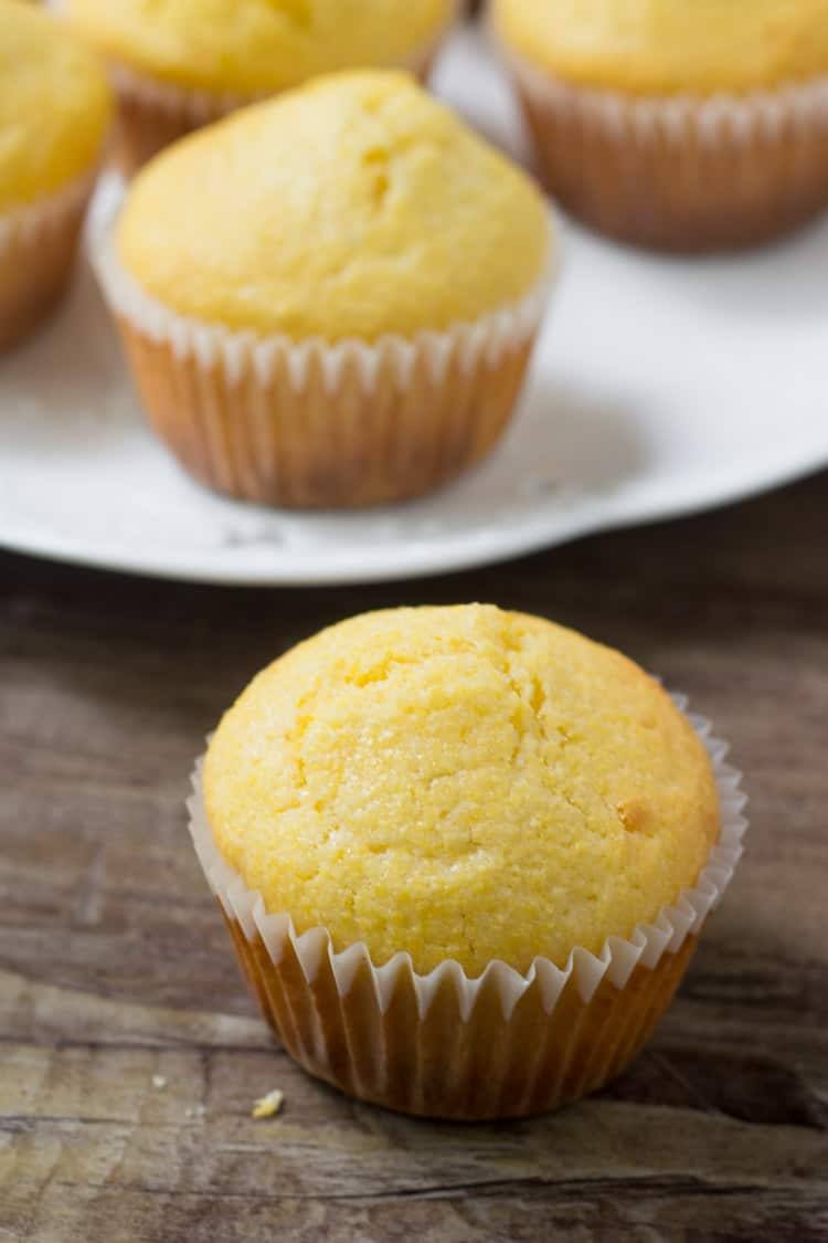 a cornbread muffing being served on a wood counter