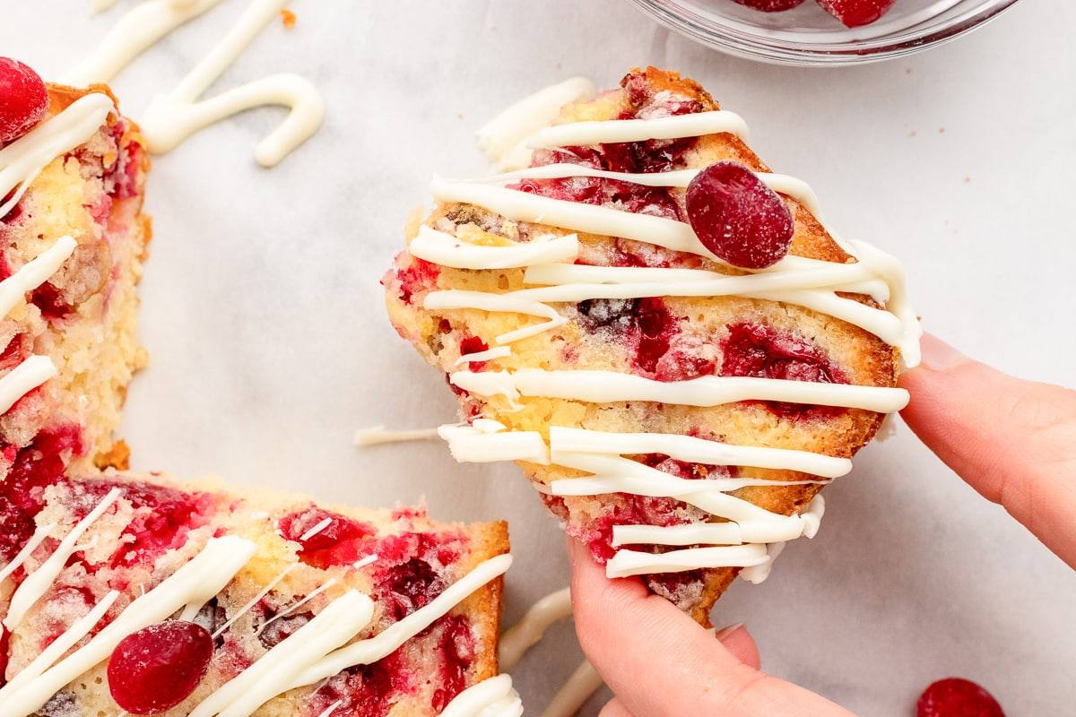 hand holding a lemon cranberry square