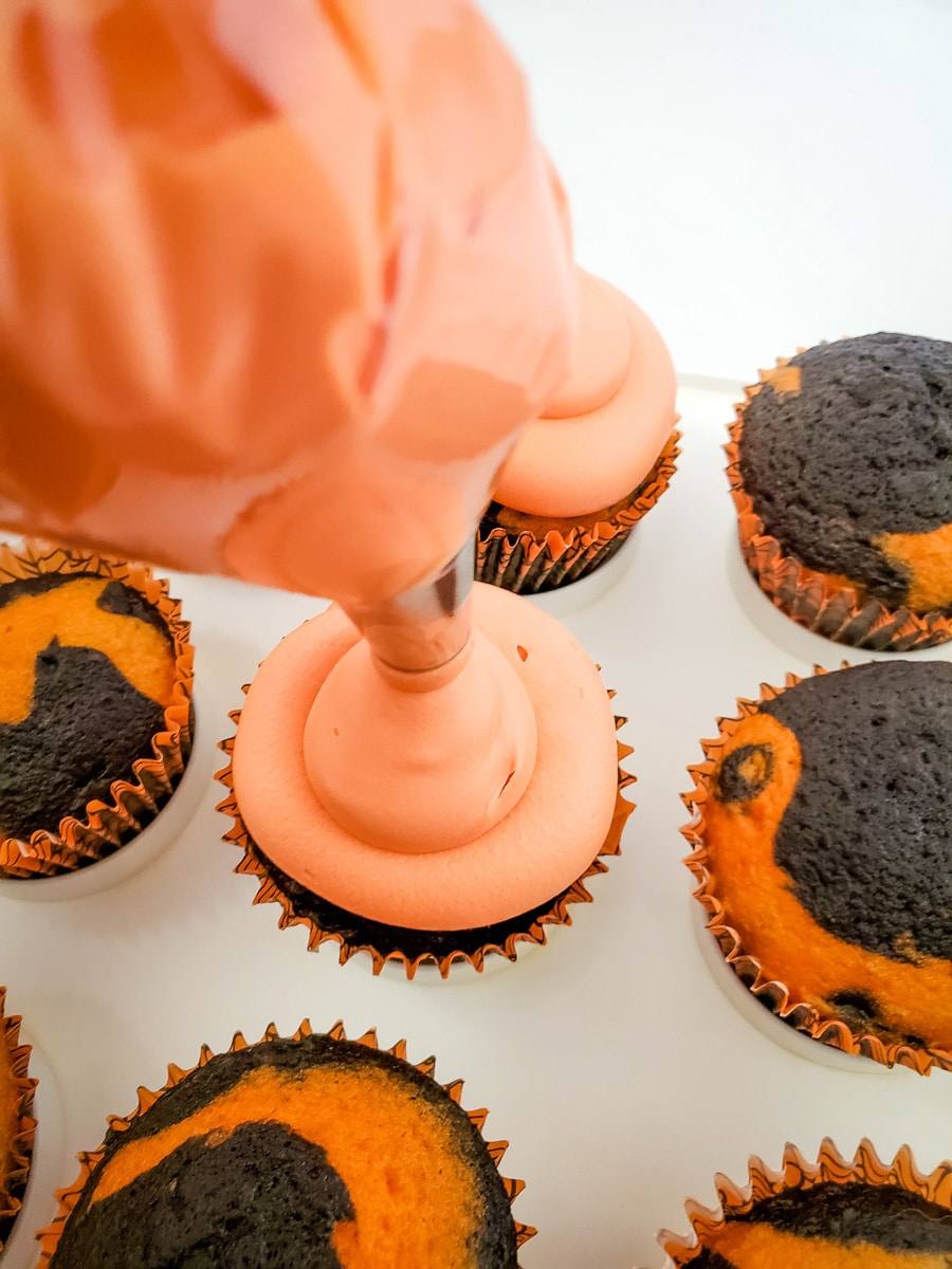tie-dye inspired orange and black cupcake