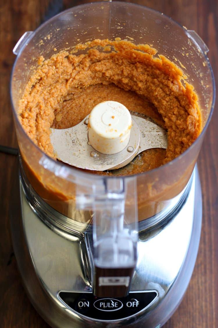 Blended pumpkin hummus in the bowl of a food processor