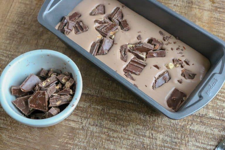 Double Chocolate No Churn Ice Cream in bread tin with chocolate chunks on top.