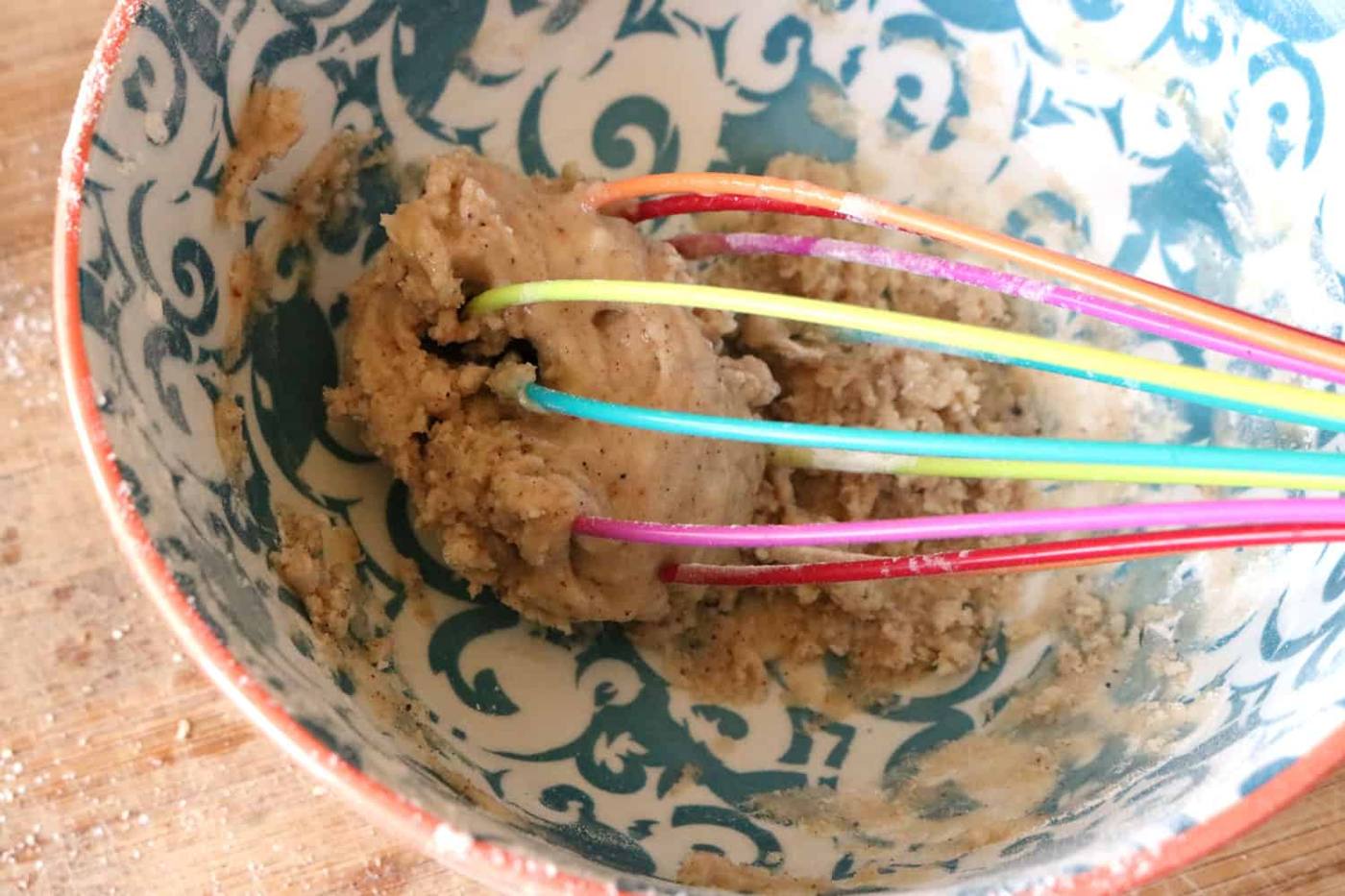 Whisking egg and dry bread pudding ingredients together.