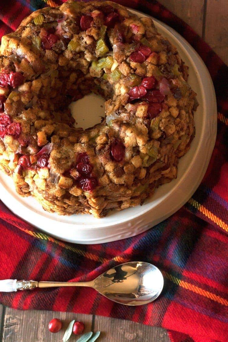 Cranberry sausage stuffing served on a white plate at a Thanksgiving dinner