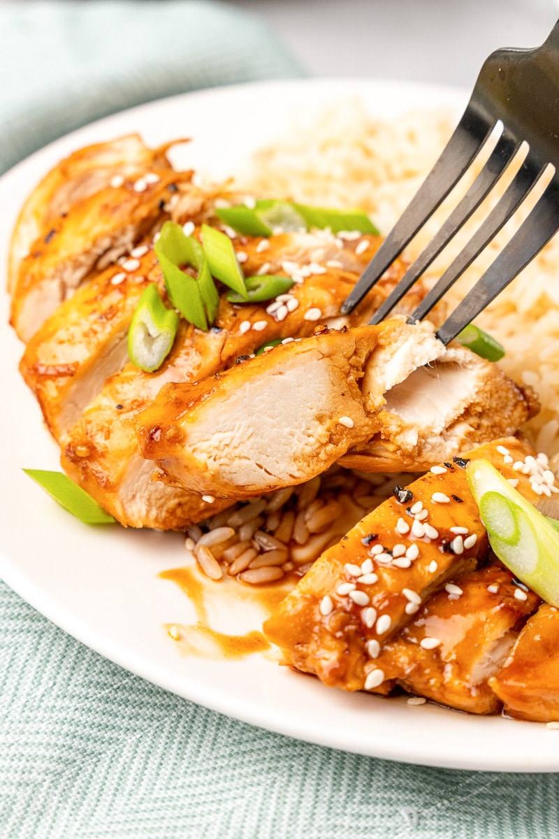 fork digging into my honey sesame chicken dish