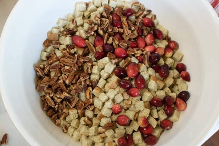 some of the ingredients for Instant Pot Cranberry Pecan Stuffing in a large mixing bowl