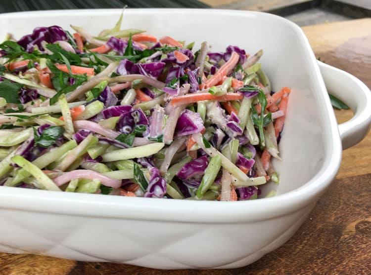 broccoli slaw in a white serving dish
