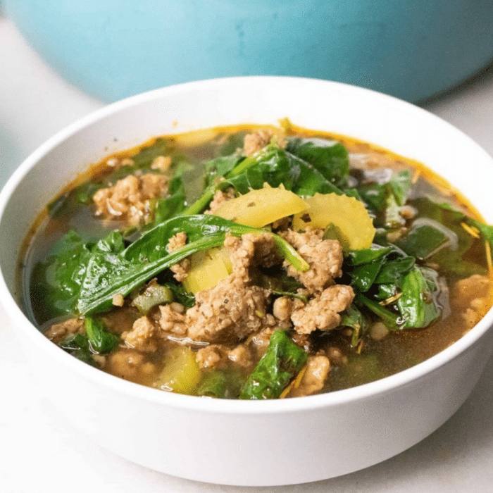 Easy keto sausage and pepper soup with spinach in a white bowl