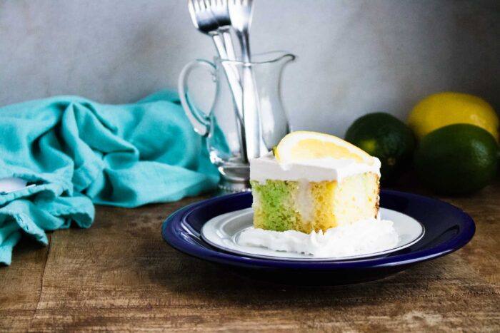 slice of lemon lime poke cake served on a blue plate