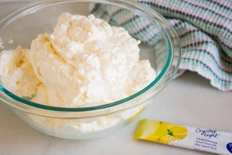 ingredients for Lemonade No-Churn Ice Cream in a clear glass mixing bowl