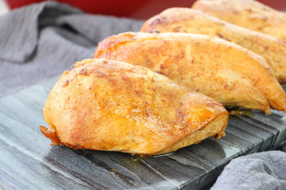 side view baked chicken on a tray