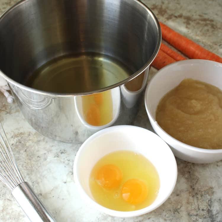 best carrot cake recipe being prepared with large stainless steel bowl and two white bowls