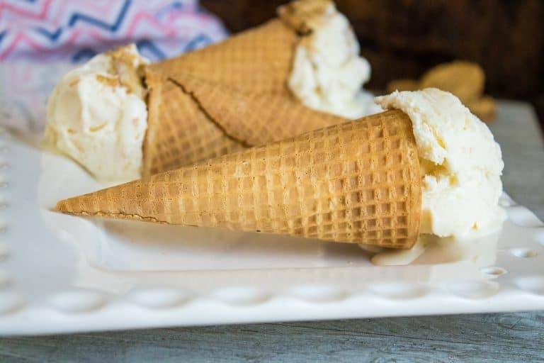 Nutter Butter No-Churn Ice Cream scooped into sugar cones and served on a white platter