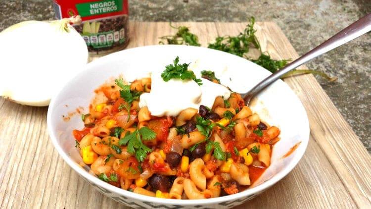 Southwest chili mac with macaroni, black beans and corn served in a white bowl