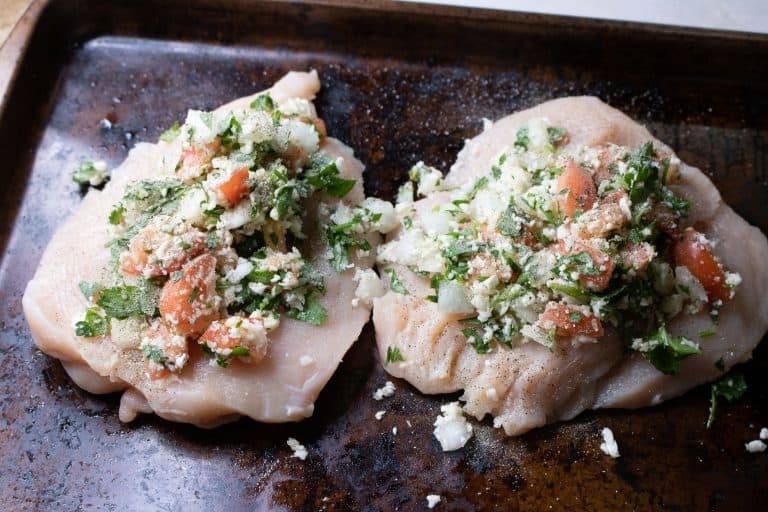 Open faced Baked Chicken Stuffed with Pico de Gallo Cauliflower Rice on a baking pan