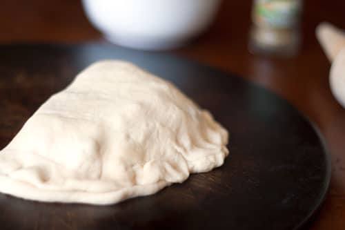 pizza calzones baked and ready to eat on a black turntable