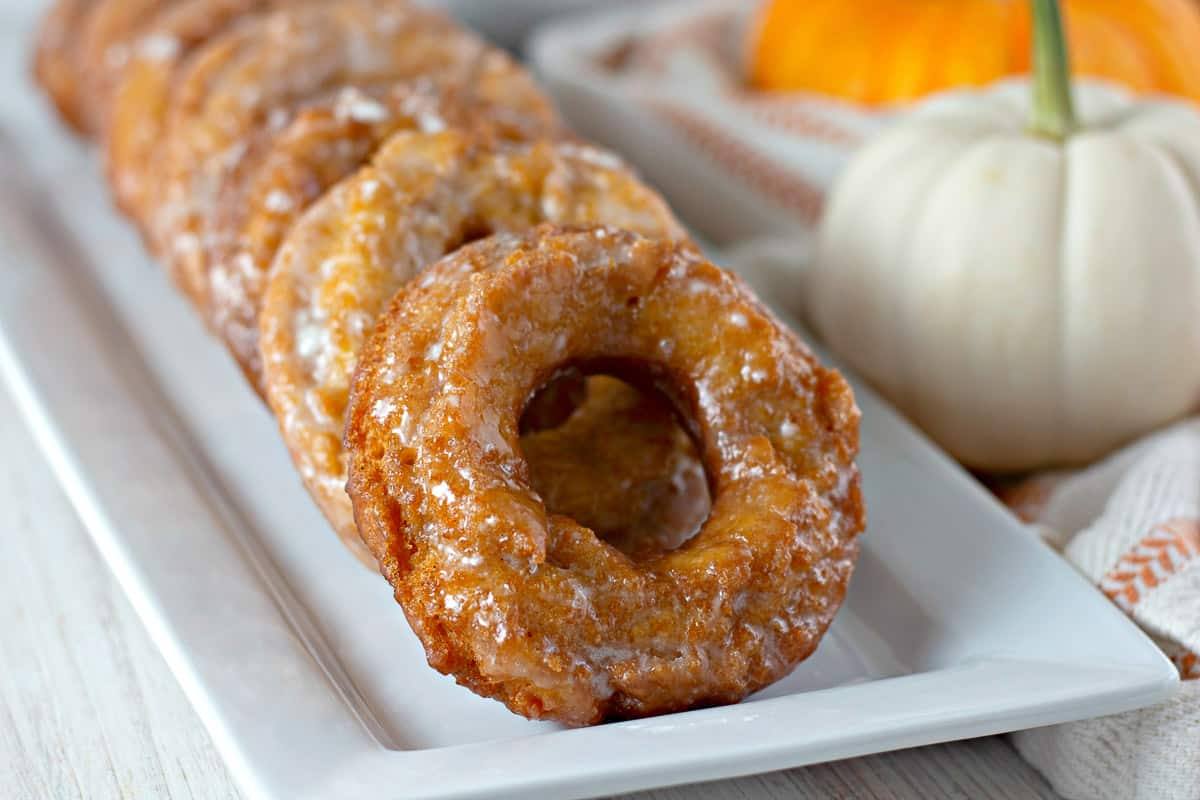 Close-up row of glazed pumpkin donuts