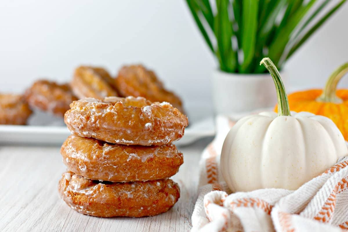 Stack of pumpkin donuts with buttermilk glaze