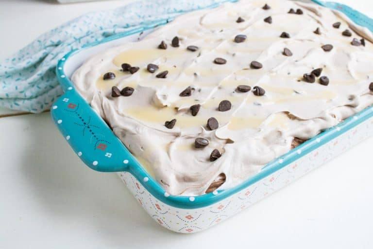 completed baked quadruple chocolate poke cake in 13x9 glass floral pan