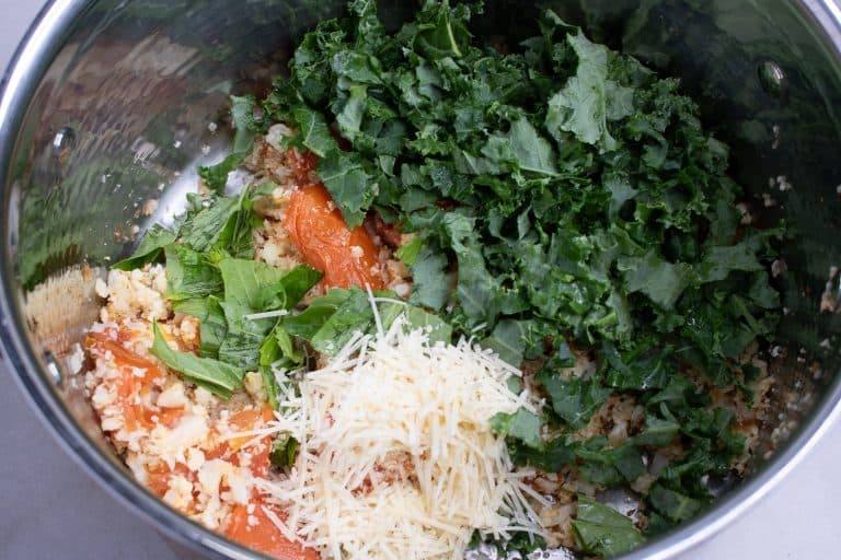 Roasted cauliflower rice, roasted tomatoes, chopped kale, fresh basil and shredded Parmesan in a stock pot