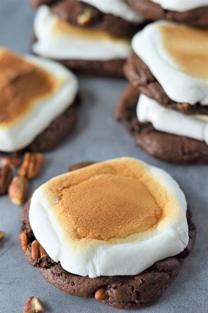 rocky road cookie on gray table with stack of cookies in background