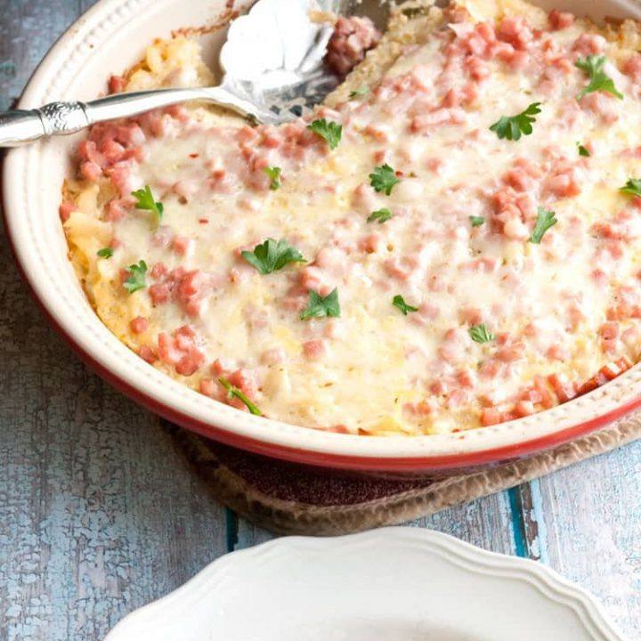Overnight southwest breakfast casserole on a plate next to a bag of Simply Potatoes shredded hash browns