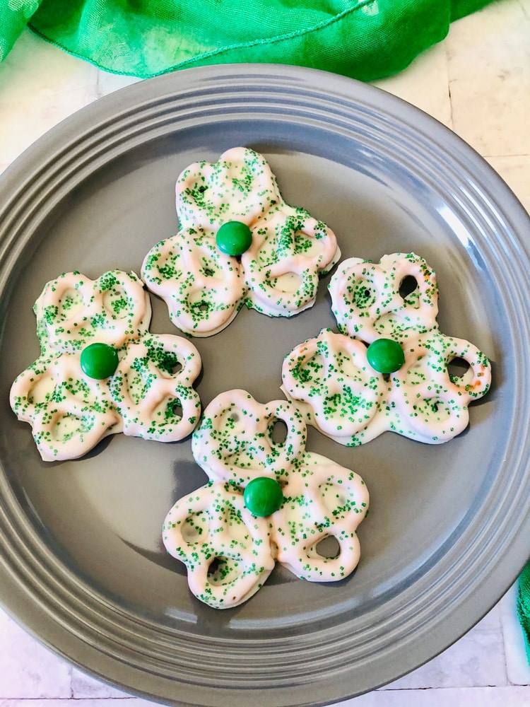 four shamrock pretzels on plate