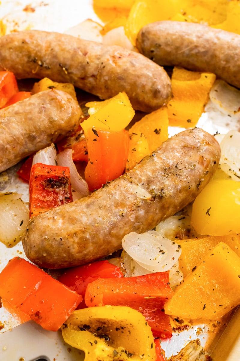 close up of sheet pan italian sausage and peppers on baking sheet