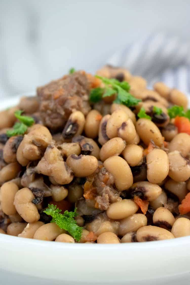 Close-up of slow cooker black eyed peas with beef stew meat, carrots and fresh parsley
