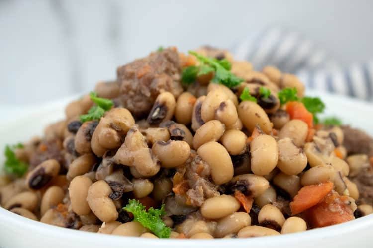 Slow cooker black eyed peas with beef in a white serving dish