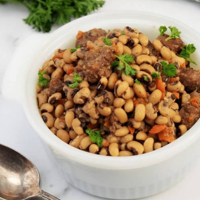Slow cooker black eyed peas with beef stew meat in a white serving dish