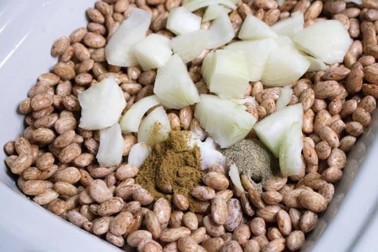 Pinto beans, onions and spices for Slow Cooker Pinto Beans in pan