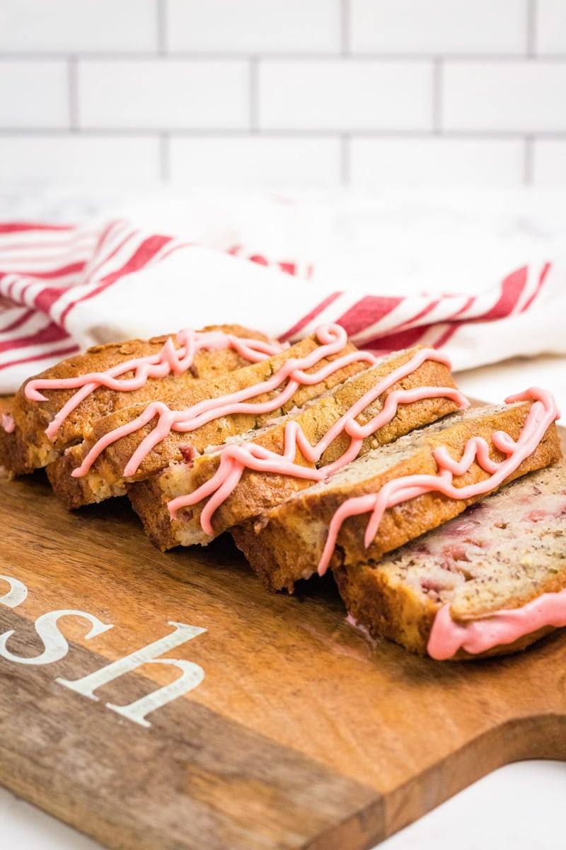 slices of strawberry banana bread on a cutting board