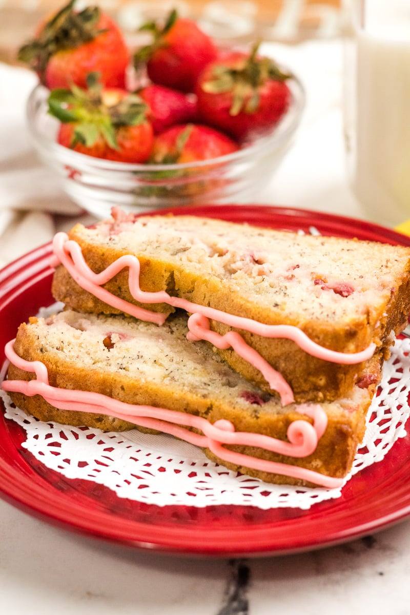slices of strawberry banana bread close up, on a red plate