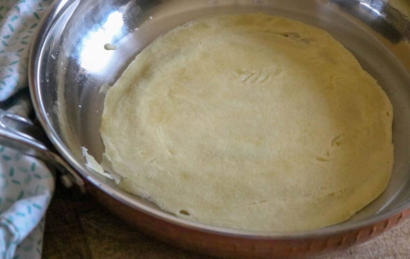 a crepe cooking in the pan