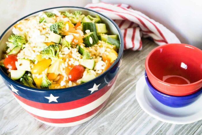 Summer Orzo Salad in a patriotic red white and blue design serving bowl